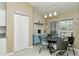 Bright dining area with a round table and a cozy blue accent cabinet with view of an outdoor patio at 5320 Hyland Hills Ave # 2222, Sarasota, FL 34241