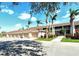 View of condo garages and units, sidewalks, mature palms and landscaping at 5320 Hyland Hills Ave # 2222, Sarasota, FL 34241