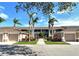 Well-maintained condo building with mature landscaping, sidewalks, and attached garages at 5320 Hyland Hills Ave # 2222, Sarasota, FL 34241