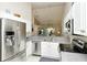 Bright kitchen with stainless steel appliances, white cabinets, and open layout at 5320 Hyland Hills Ave # 2222, Sarasota, FL 34241