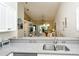 Bright kitchen with stainless steel appliances and view to the living area at 5320 Hyland Hills Ave # 2222, Sarasota, FL 34241