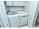 Convenient laundry room featuring a modern washer and dryer set and overhead storage at 5320 Hyland Hills Ave # 2222, Sarasota, FL 34241