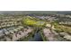 Community aerial view featuring waterways, manicured landscaping, and tile roofs, showcasing a desirable neighborhood setting at 5539 Octonia Pl, Sarasota, FL 34238