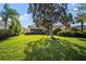 Large, verdant backyard with mature trees, perfect for outdoor activities and relaxation at 5539 Octonia Pl, Sarasota, FL 34238
