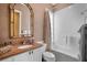 Well-lit bathroom featuring a shower-tub combo and tan and white finishes at 5539 Octonia Pl, Sarasota, FL 34238
