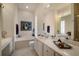 Bright bathroom with tub, white cabinets, and a large countertop at 5539 Octonia Pl, Sarasota, FL 34238