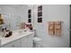 Clean bathroom with a shower, toilet, and a white vanity with decorations at 5539 Octonia Pl, Sarasota, FL 34238