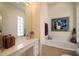 Bright bathroom with tub, white cabinets, and a large countertop at 5539 Octonia Pl, Sarasota, FL 34238