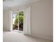 Bright bedroom with access to outdoor garden area, neutral decor, and stylish drapery at 5539 Octonia Pl, Sarasota, FL 34238
