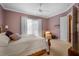 Relaxing bedroom featuring neutral walls, large windows, and a comfortable bed at 5539 Octonia Pl, Sarasota, FL 34238