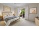 Stylishly staged bedroom featuring a king-sized bed, neutral decor, and sliding doors to a private patio at 5539 Octonia Pl, Sarasota, FL 34238