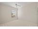 Neutral bedroom with a bright window, a ceiling fan, and neutral decor at 5539 Octonia Pl, Sarasota, FL 34238