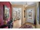 Inviting foyer with light wood floors, elegant decor, and doorway to the home office at 5539 Octonia Pl, Sarasota, FL 34238