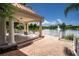 Covered gazebo with classic columns and brick flooring provides shade and a view of the lake fountain at 5539 Octonia Pl, Sarasota, FL 34238