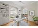 Bright home office with built-in bookshelves, modern desk, and large windows with a view at 5539 Octonia Pl, Sarasota, FL 34238