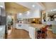 Well-lit kitchen with breakfast bar, white cabinetry, recessed lighting, and open access to the living room at 5539 Octonia Pl, Sarasota, FL 34238