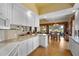 Contemporary kitchen with granite countertops, white cabinets, tile backsplash, and stainless steel appliances at 5539 Octonia Pl, Sarasota, FL 34238