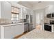 Bright kitchen with stainless steel appliances, white cabinets, granite countertops and garden view at 5539 Octonia Pl, Sarasota, FL 34238