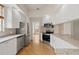 Modern kitchen featuring stainless steel appliances, granite countertops, and ample cabinet space at 5539 Octonia Pl, Sarasota, FL 34238