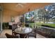 Relaxing screened-in lanai with seating area, offering picturesque lake views at 5539 Octonia Pl, Sarasota, FL 34238