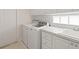 Well-equipped laundry room with modern appliances, ample counter space, and lots of storage at 5539 Octonia Pl, Sarasota, FL 34238