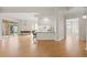Open-concept living space featuring hardwood floors and an adjoining kitchen and dining area at 5539 Octonia Pl, Sarasota, FL 34238