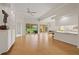 Bright living room with vaulted ceilings, neutral walls, and views of the screened lanai and garden at 5539 Octonia Pl, Sarasota, FL 34238