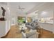 Bright living room with vaulted ceilings, neutral walls, and views of the screened lanai and garden at 5539 Octonia Pl, Sarasota, FL 34238