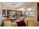 Living room featuring sliding glass doors with outdoor access, a ceiling fan, and adjacent dining area at 5539 Octonia Pl, Sarasota, FL 34238
