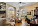 Comfortable home office with built-in shelves, bright windows, and a ceiling fan at 5539 Octonia Pl, Sarasota, FL 34238