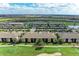Aerial view of a residential area with pristine golf courses, serene ponds, and well-maintained landscaping at 5710 Palmer Cir # 204, Lakewood Ranch, FL 34211