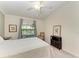 Comfortable bedroom with a full-size bed, neutral decor, and a bright window with peaceful views at 5710 Palmer Cir # 204, Lakewood Ranch, FL 34211