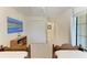 Bright bedroom with two twin beds, white walls, a closet, and an outdoor-view window at 5710 Palmer Cir # 204, Lakewood Ranch, FL 34211