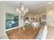Open dining room featuring a wooden table set below a modern chandelier, next to an outdoor patio at 5710 Palmer Cir # 204, Lakewood Ranch, FL 34211