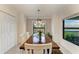 Bright dining room with a wooden table and views of the outdoors through a large window at 5710 Palmer Cir # 204, Lakewood Ranch, FL 34211