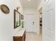 Tastefully decorated hallway with a console table, mirror, and a view into the bedroom at 5710 Palmer Cir # 204, Lakewood Ranch, FL 34211