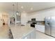 Spacious kitchen with a large island, stainless steel appliances, white cabinets, and granite countertops at 5710 Palmer Cir # 204, Lakewood Ranch, FL 34211