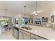 Open-concept kitchen island that offers counter seating with clear view to the outside patio and Gathering room at 5710 Palmer Cir # 204, Lakewood Ranch, FL 34211