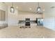 A close-up view of a kitchen island with granite countertops, double sinks, and modern pendant lighting at 5710 Palmer Cir # 204, Lakewood Ranch, FL 34211