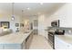 Open concept kitchen with a granite island, stainless steel appliances, and seamless flow to living area at 5710 Palmer Cir # 204, Lakewood Ranch, FL 34211