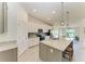 Bright kitchen features white cabinetry, stainless steel appliances, granite counters, and a large center island at 5710 Palmer Cir # 204, Lakewood Ranch, FL 34211