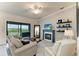 Inviting living room featuring a fireplace, comfortable seating, and sliding glass doors to the outside deck at 5710 Palmer Cir # 204, Lakewood Ranch, FL 34211
