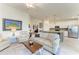 Comfortable living room with a fireplace, coffee table, and view into the open kitchen space at 5710 Palmer Cir # 204, Lakewood Ranch, FL 34211