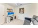 Comfortable space with a blue sofa, TV and shelving, offering a relaxing and functional layout at 5710 Palmer Cir # 204, Lakewood Ranch, FL 34211