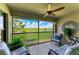 Serene screened lanai with comfortable chairs and scenic views of the lush golf course and lake at 5710 Palmer Cir # 204, Lakewood Ranch, FL 34211