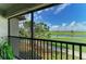 Golf course view from a screened lanai with comfortable chairs and beautiful Florida scenery at 5710 Palmer Cir # 204, Lakewood Ranch, FL 34211