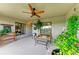 Relaxing screened lanai with comfortable seating, ceiling fan, and views of the outdoors at 5710 Palmer Cir # 204, Lakewood Ranch, FL 34211