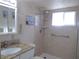 Bathroom with granite vanity top and walk-in shower with built-in shelving at 5889 Garden Ln # H4, Bradenton, FL 34207