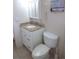 Bathroom with white vanity, granite countertop, framed mirror, and toilet with tiled floor at 5889 Garden Ln # H4, Bradenton, FL 34207