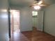 Spacious bedroom features a walk-in closet, wood laminate flooring and an ensuite bath at 5889 Garden Ln # H4, Bradenton, FL 34207